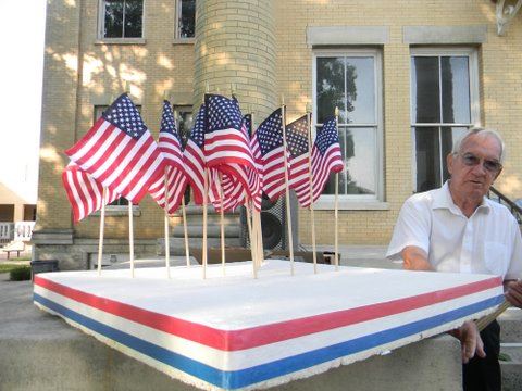 Man standing beside mini-flags ina a styrofoam holder